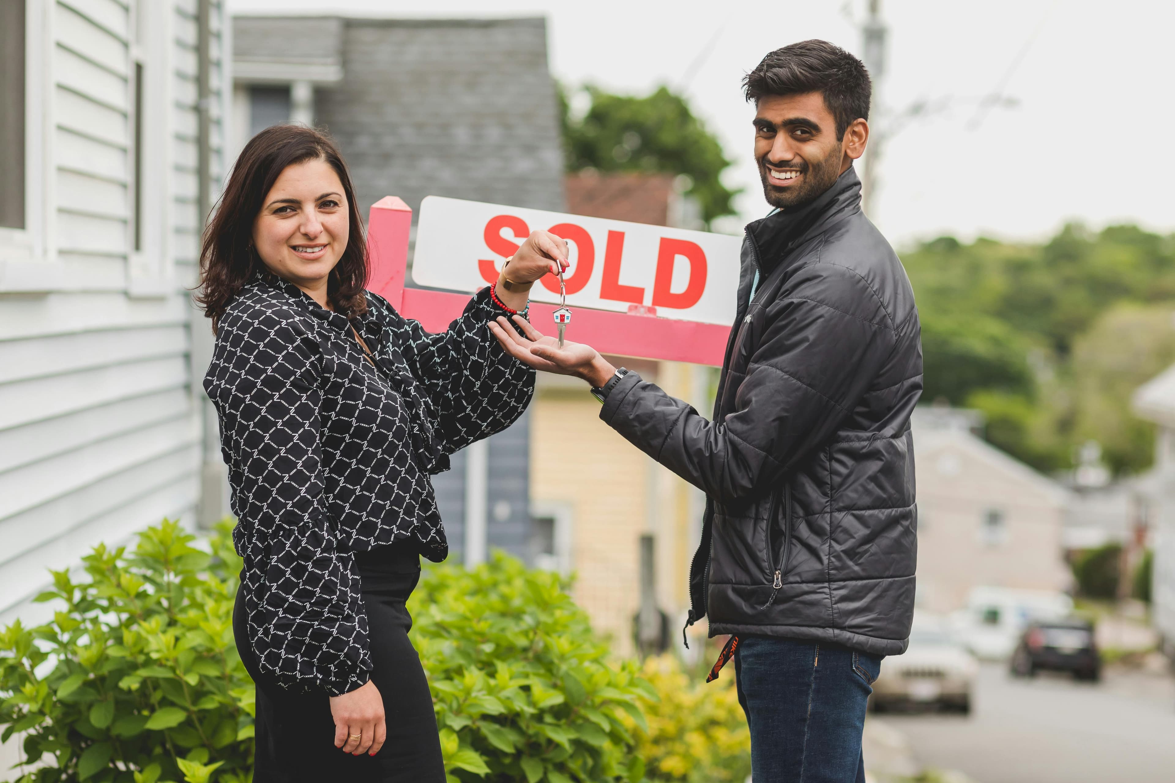 Real estate agent handing keys to a client